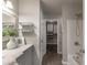 Bathroom with a walk-in closet, modern sink, and shower over tub at 4408 Brandon Ne Ct, Marietta, GA 30066