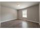 Bright bedroom with hardwood floors, neutral walls, and a large window at 4408 Brandon Ne Ct, Marietta, GA 30066
