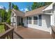 Charming front porch and home exterior featuring gray siding and blue shutters with a wooden deck at 4408 Brandon Ne Ct, Marietta, GA 30066