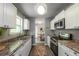 Modern kitchen with white cabinets, stainless steel appliances, and convenient dining area at 4408 Brandon Ne Ct, Marietta, GA 30066