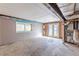 Unfinished basement with exposed ceiling, window, and a door to the backyard allows customization at 143 Longview Rd, Fayetteville, GA 30214