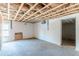 Unfinished basement showing concrete walls and ceiling, leading to a space ready for renovation and design at 143 Longview Rd, Fayetteville, GA 30214