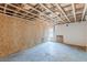 Unfinished basement with a partially painted walls, a window and cement floors ready for flooring at 143 Longview Rd, Fayetteville, GA 30214