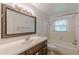 The bathroom features a large vanity and bath and shower combination with tile surround at 143 Longview Rd, Fayetteville, GA 30214