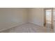 A neutral toned bedroom features carpet and an ensuite bathroom for added convenience at 143 Longview Rd, Fayetteville, GA 30214