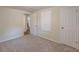 A carpeted bedroom offers ample storage with a wardrobe and closet and features neutral paint at 143 Longview Rd, Fayetteville, GA 30214