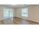 Bright bedroom features wood flooring, a sliding glass door, and a view of the screened-in porch at 143 Longview Rd, Fayetteville, GA 30214