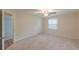 Spacious bedroom with neutral carpet, a ceiling fan, and natural light from a window at 143 Longview Rd, Fayetteville, GA 30214