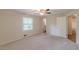 Spacious bedroom with neutral carpet, light walls, and a ceiling fan, offering a comfortable retreat at 143 Longview Rd, Fayetteville, GA 30214