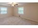 Bright bedroom featuring neutral carpet, two windows, and ceiling fan, creating a serene atmosphere at 143 Longview Rd, Fayetteville, GA 30214