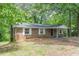 Brick home with white shutters and covered entrance offering a blend of classic design and outdoor charm at 143 Longview Rd, Fayetteville, GA 30214