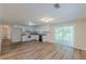 Open kitchen with white cabinets, wood flooring, and sliding glass doors to the deck at 143 Longview Rd, Fayetteville, GA 30214