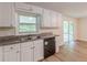 The kitchen features white cabinets, granite countertops, and stainless steel appliances at 143 Longview Rd, Fayetteville, GA 30214