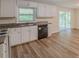 Kitchen features white cabinets, granite countertops, a black dishwasher, and access to the deck at 143 Longview Rd, Fayetteville, GA 30214