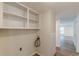 Well-lit laundry area with built-in shelving and modern flooring offering both functionality and style at 143 Longview Rd, Fayetteville, GA 30214