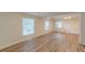 The light-filled living room features wood floors, a beamed ceiling, and oversized windows at 143 Longview Rd, Fayetteville, GA 30214