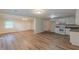 This open-concept living space features a modern kitchen with white cabinets and stainless appliances at 143 Longview Rd, Fayetteville, GA 30214