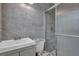Bathroom with a sink, toilet and tiled shower behind a clear glass door at 4002 Phylis Pl, Decatur, GA 30035