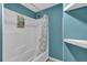 Bathroom featuring a shower with a curtain, alongside white wall shelves at 4002 Phylis Pl, Decatur, GA 30035