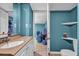 Cozy bathroom featuring a single sink vanity, mirror, toilet, and storage area at 4002 Phylis Pl, Decatur, GA 30035