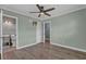 Bedroom with a ceiling fan and adjoining bathroom featuring gray tiled walls at 4002 Phylis Pl, Decatur, GA 30035