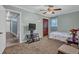Bedroom featuring hardwood floors in the hallway, wall-mounted television, and comfortable decor at 4002 Phylis Pl, Decatur, GA 30035