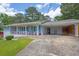 View of the carport featuring a wood accent wall, storage cabinet, and access to the house at 4002 Phylis Pl, Decatur, GA 30035