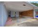 Spacious carport featuring a brick accent wall and access to a storage room or utility area at 4002 Phylis Pl, Decatur, GA 30035