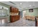 Open kitchen and dining area with tile floors, traditional cabinets, and stone fireplace in the nearby living room at 4002 Phylis Pl, Decatur, GA 30035