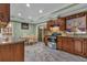 Eat-in kitchen features stainless steel appliances, granite countertops, and traditional wood cabinetry at 4002 Phylis Pl, Decatur, GA 30035
