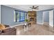 Cozy living room featuring hardwood floors, a stone fireplace, and a large window at 4002 Phylis Pl, Decatur, GA 30035