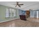 Open living room with hardwood floors, a stone fireplace, and plenty of natural light at 4002 Phylis Pl, Decatur, GA 30035