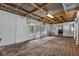 Enclosed porch with corrugated metal roofing, hardwood floors, and windows for natural light at 4002 Phylis Pl, Decatur, GA 30035