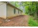 Image shows the backyard with some concrete bricks next to the house and lush green trees at 5856 Rock Rd, Union City, GA 30291