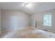 A bare bedroom with a mirror and a view of the trees outside the window at 5856 Rock Rd, Union City, GA 30291
