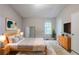 Comfortable bedroom with a large bed, dresser, and minimalist decor at 5856 Rock Rd, Union City, GA 30291
