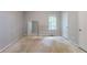 A bare bedroom with a mirror and a view of the trees outside the window at 5856 Rock Rd, Union City, GA 30291