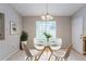 Bright dining area featuring a glass table, white chairs, and a window with natural light at 5856 Rock Rd, Union City, GA 30291