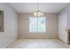 A dining room with a view of a living area, next to a window with blinds and light fixture at 5856 Rock Rd, Union City, GA 30291