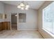 A dining room with a view of a living area, next to a window with blinds and light fixture at 5856 Rock Rd, Union City, GA 30291