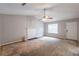 A bare living room with a fireplace and ceiling fan, ready for customization at 5856 Rock Rd, Union City, GA 30291