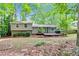 Backyard with a well-maintained lawn, string lights, a wood deck, and lush trees at 604 Continental Dr, Lawrenceville, GA 30044