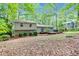 Backyard with a well-maintained lawn, wood deck, and lush trees at 604 Continental Dr, Lawrenceville, GA 30044