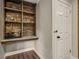 An elegant bar with a wooden design, open shelving, glassware, and stylish decor at 604 Continental Dr, Lawrenceville, GA 30044