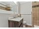 Well-lit bathroom with tiled shower and updated vanity with marble countertop at 604 Continental Dr, Lawrenceville, GA 30044