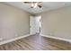 Neutral bedroom features wood floors, ceiling fan, and neutral walls for a calm retreat at 604 Continental Dr, Lawrenceville, GA 30044