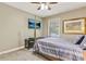 This bedroom features a four poster bed, a TV, and a large window at 604 Continental Dr, Lawrenceville, GA 30044