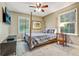 This bedroom features a four poster bed, a TV, and large windows at 604 Continental Dr, Lawrenceville, GA 30044