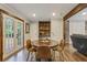 Dining area featuring hardwood floors, a table for four, a beautiful built-in hutch, and French doors to the outside at 604 Continental Dr, Lawrenceville, GA 30044