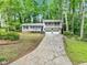 Traditional two-story home with a long driveway, a front porch, and two-car garage at 604 Continental Dr, Lawrenceville, GA 30044